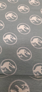 Baumwolljersey grün mit Dinosaurierköpfen