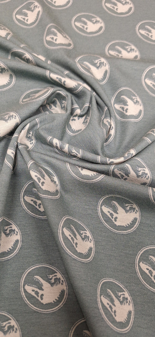 Baumwolljersey grün mit Dinosaurierköpfen