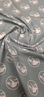 Baumwolljersey grün mit Dinosaurierköpfen