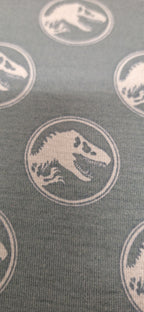 Baumwolljersey grün mit Dinosaurierköpfen