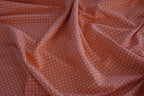Baumwolljersey orange mit weißen Punkten