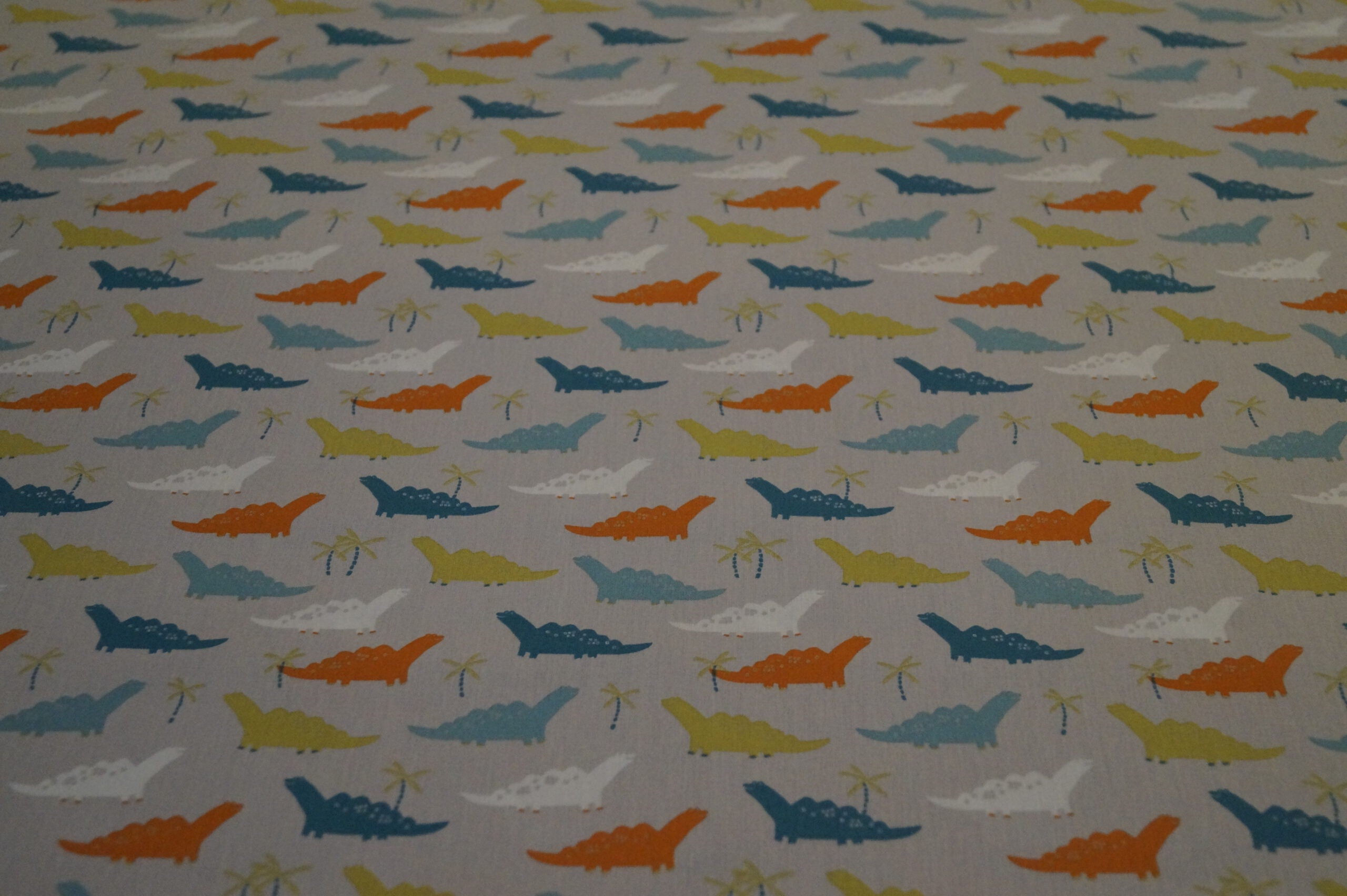 Popeline grau mit Dinos