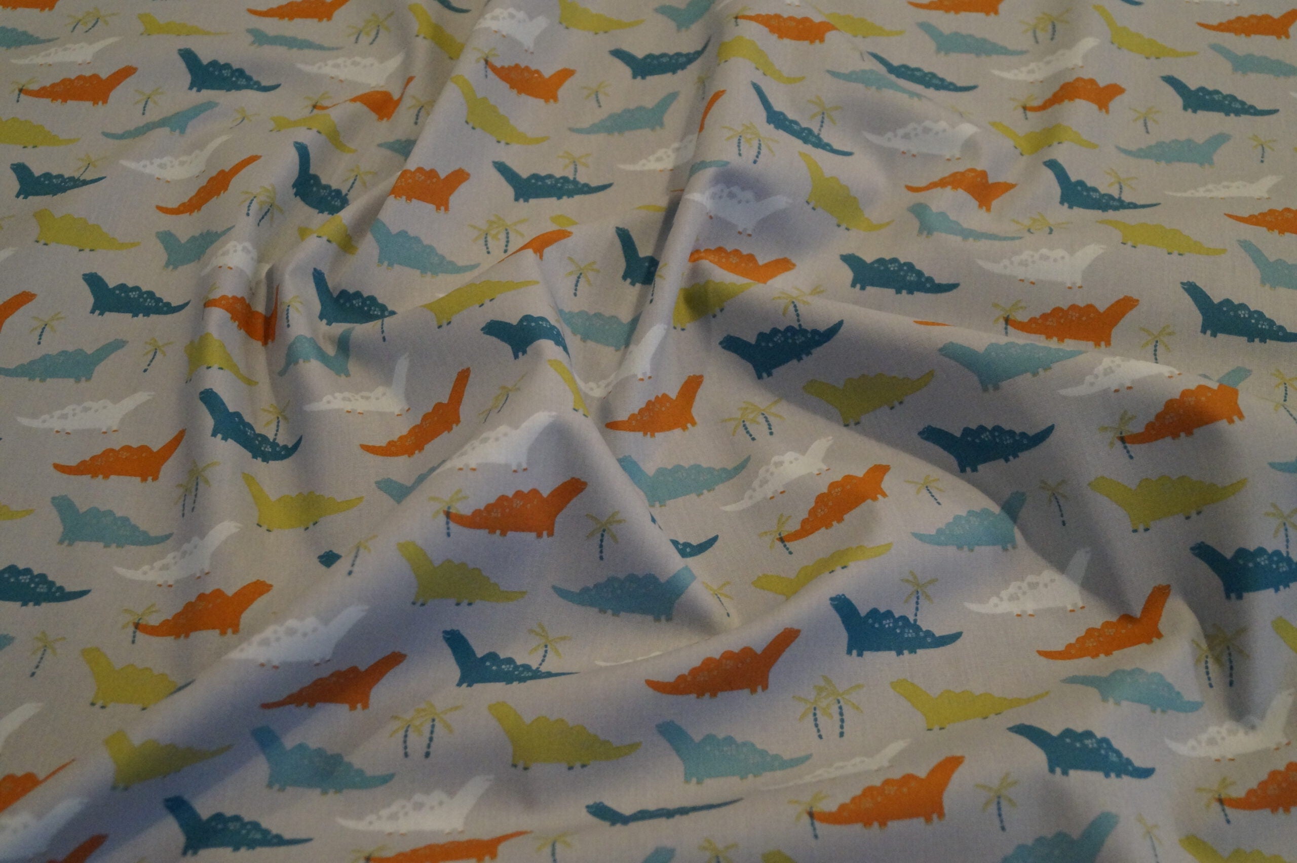 Popeline grau mit Dinos