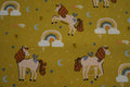 Popeline ockerfarben mit Einhörnern und Regenbogen