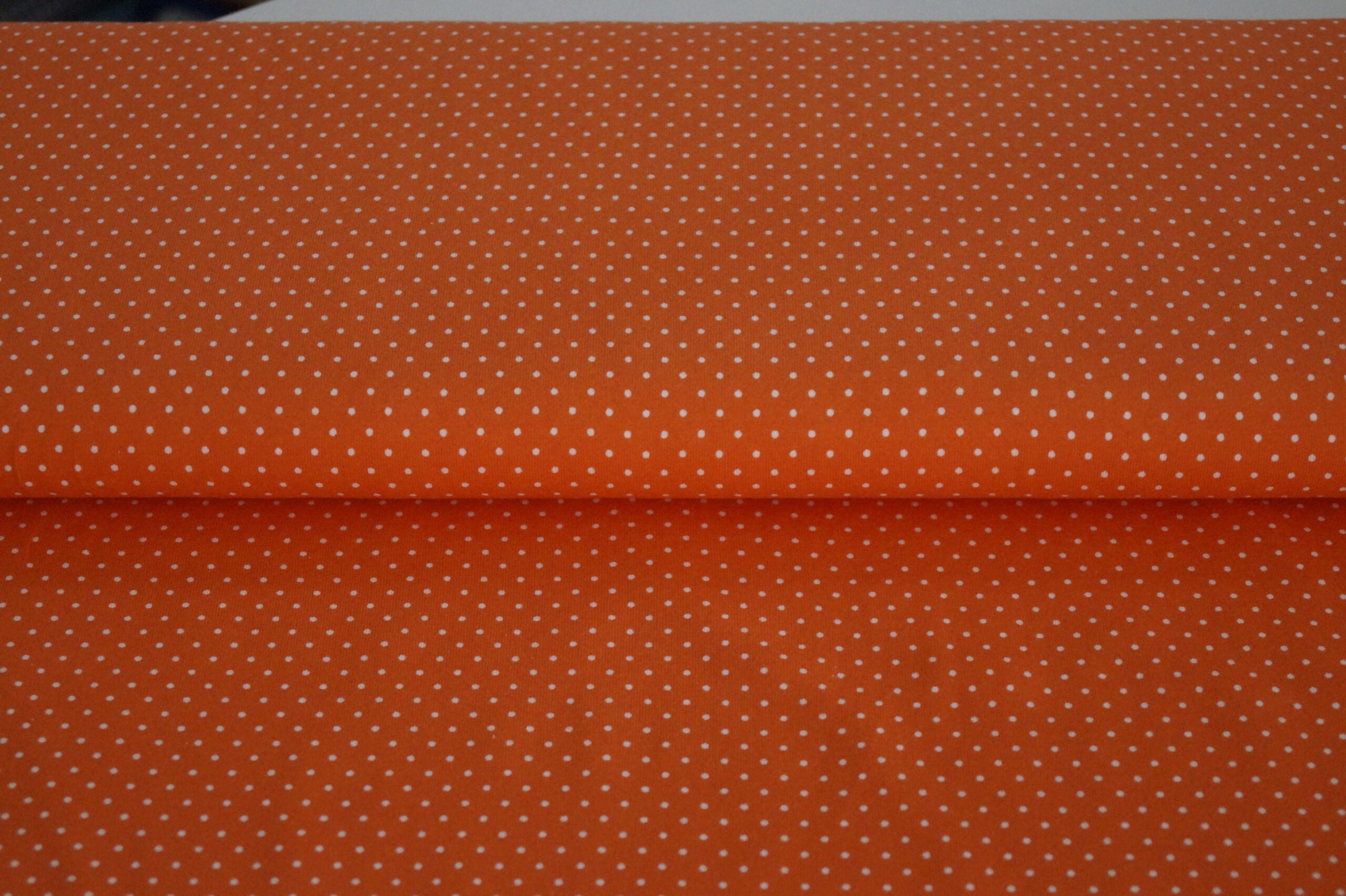 Baumwolljersey orange mit weißen Punkten